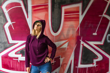 CESKE BUDEJOVICE,CZECH REPUBLIC - August 19,2019 - Portrait of young woman standing before graffiti