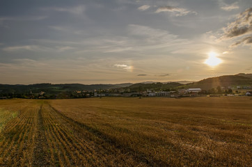 City Cesky Krumlov at sunset with mowed field