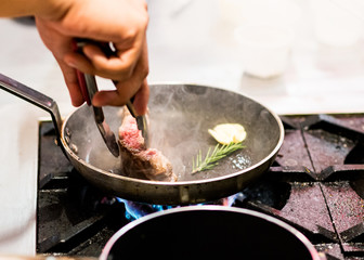 Chef cooking, Chef preparing food in the kitchen, closeup.