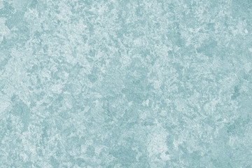 Light green textured concrete wall. Stucco of gray wall. Abstract pattern with grey spots of paint on the surface.
