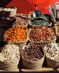 Hazelnuts, cashews, almonds, peanuts,toasted corn and sunflower seeds in straw baskets on the store shelf