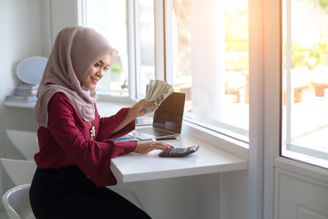 Muslim women use calculators and count money at work.