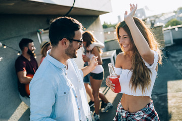 Happy group of young friends having fun in summer