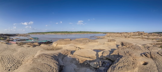Fototapeta na wymiar River view panorama morning of arch rocks wonder shape and sand around with Mekong river and blue sky background, Sam Phan Bok, Ubon Ratchathani, Thailand.