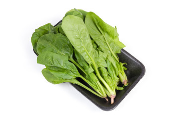 Leaves of fresh spinach on the foam food container