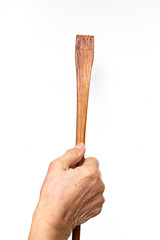 Senior woman's hand holding wood back scratcher on white background, About massage