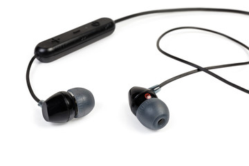 Black wireless earphones close-up on a white background