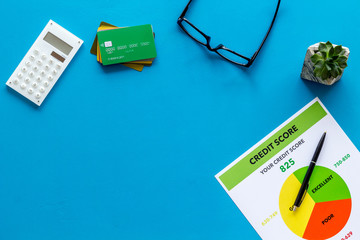 credit score with credit cards and keyboard on banker work place yellow background top view copyspace