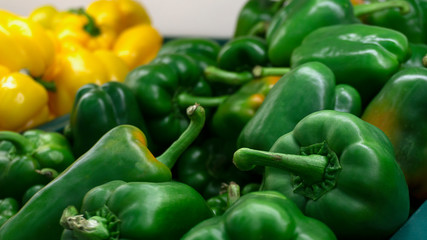 Green peppers raw many in a basket for sale in the market. Ingredients for cooking. food concept.