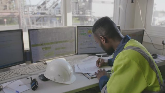 factory worker writing down notes