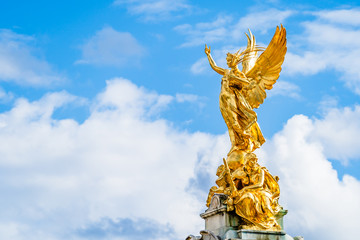 Victory Goddess golden statue on top of the Victoria Memorial located in front of Buckingham Palace...
