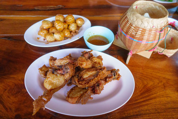 Special thai food fried chicken on wooden table.