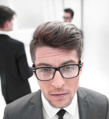 close up.confident young businessman on blurred office background