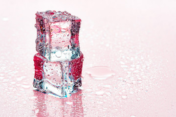 Ice cubes on pink background