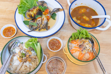 White rice mix crab, Crab's spawn, sour soup with ryukyu egg fish, salmon and pickled crab eggs seafood in Food carrier on wooden table background.