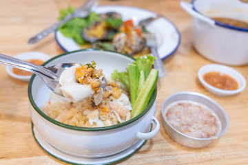 White rice mix crab and Crab's spawn seafood with cucumber in Food carrier on wooden table background.