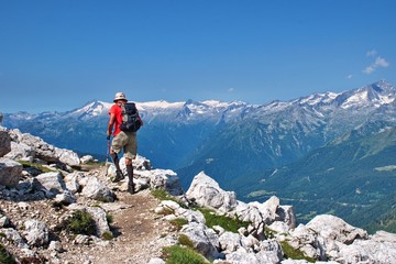 Fototapeta na wymiar Senior hiker hiking in Brenta Dolomites, Italy with scenic rocky landscape in the background