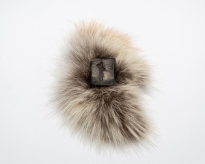 Norse rune Nautiz (Naud), isolated on fur and white  background.  Obstacles, the necessary awareness of difficulties and opportunities to overcome them. Strong bond, obligations.