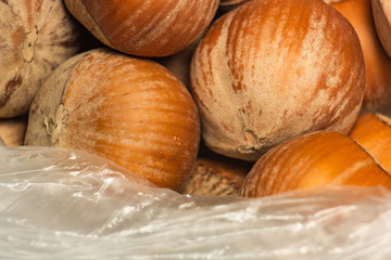 Brown hazelnuts in a plastic transparent bag