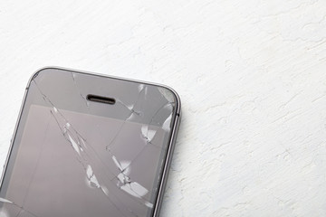 Broken glass phone. Cracks on the display of a mobile phone. Copy space for text.