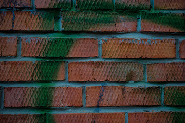 Texture of an old paint covered brick wall. Background image of an abandoned brick wall with painted over paint