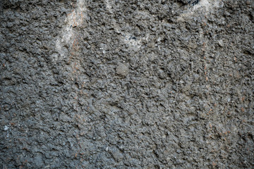 Texture of an old cracked concrete wall. Background image of a worn gray concrete surface