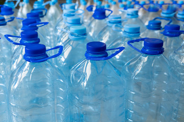 Empty plastic bottles in a rows. Plastic pollution