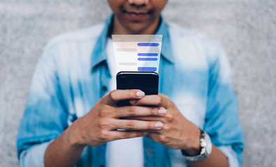 Man using chat message app on smartphone, in response to communication