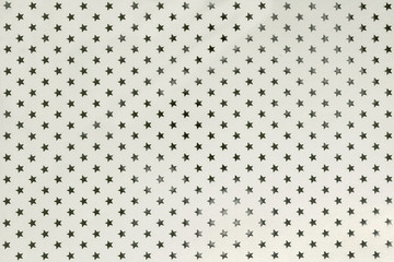 White background from metal foil paper with silver stars pattern