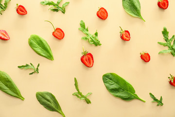 Fresh strawberry with herbs on color background
