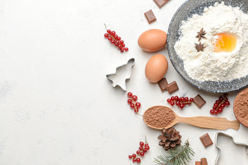 Christmas composition with cookie cutters and ingredients on white background