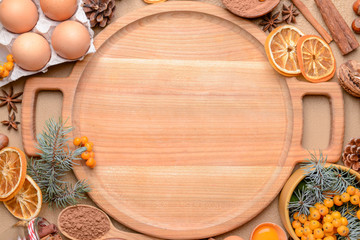 Wooden board with ingredients for Christmas pie on color background