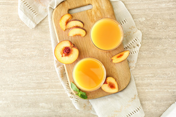 Glasses of tasty peach juice on table