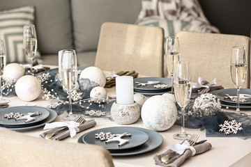 Beautiful table setting with Christmas decorations in living room
