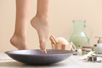 Young woman undergoing spa pedicure treatment in beauty salon