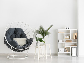 Interior of modern room with armchair and floral decor