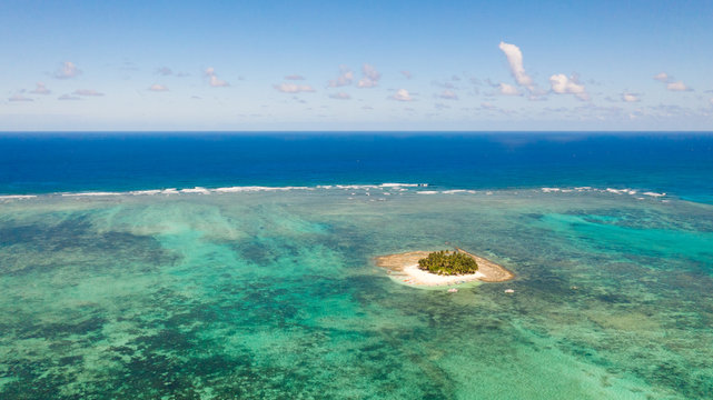 Guyam island, Siargao, Philippines. Small island with palm trees and a white sandy beach. Philippine Islands.