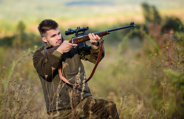 Focus and concentration of experienced hunter. Hunting and trapping seasons. Hunting permit. Man brutal gamekeeper nature background. Bearded hunter spend leisure hunting. Hunter hold rifle