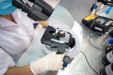 Asian technician tests the quality of product in laboratory closeup