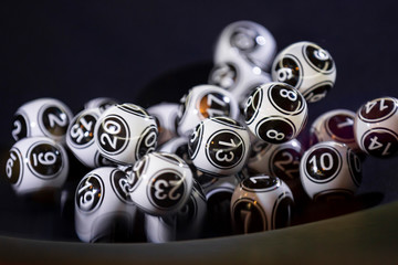 Black and white lottery balls in a machine 13