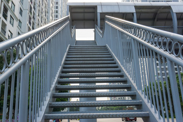 Steel stair step to walk up or walk down to the outdoor public bridge