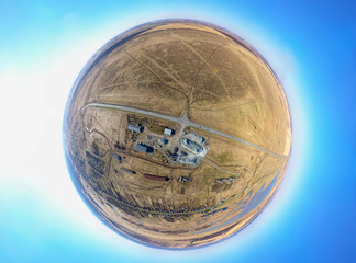 Aerial 360 little planet view of a small plant for the production and cleaning rubble and cement near the heaps of building materials from the pipe. Manufacturing industry.