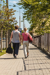 Fototapeta premium Couple man and woman walking with sport bags.