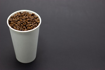 coffee beans in a glass on a dark background place for text