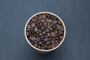 coffee beans in a glass on a dark background place for text
