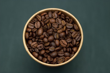 coffee beans in a glass on a dark background place for text