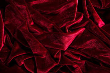 Background image of crumpled fabric. Red velvet