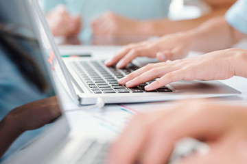 Hands of schoolkid or business person touching keys of laptop keypad
