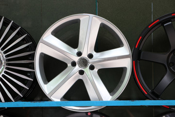 Alloy Wheel of car on the shelf. Alloy wheels are wheels that are made from an alloy of aluminium...