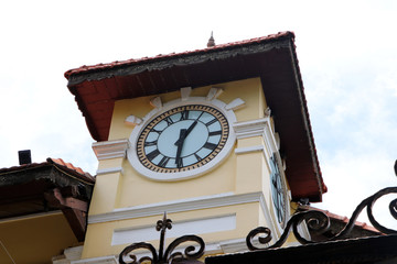 Fototapeta na wymiar Clock tower of the building on sky background.